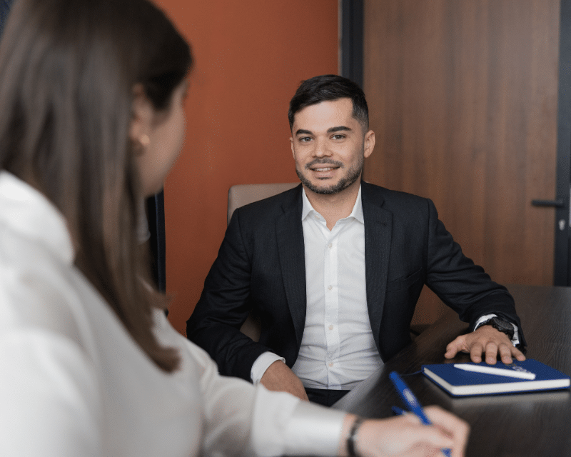 Stephen Tonna, Advisor at A2CO sitting at a desk.