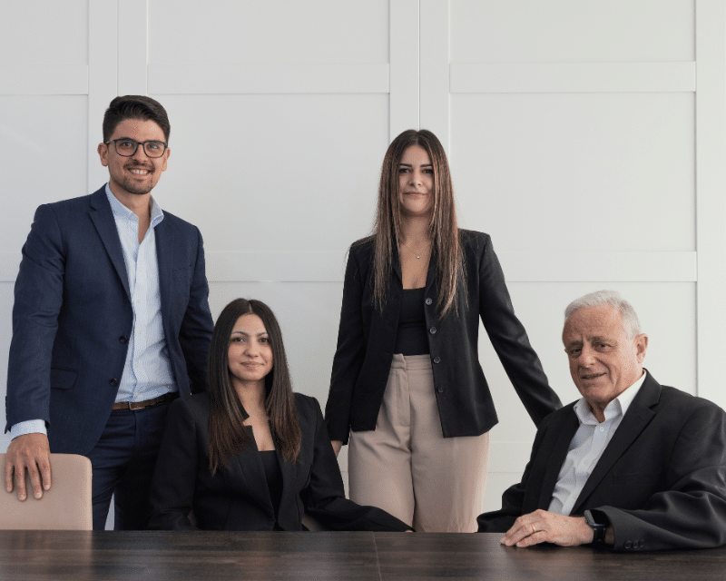 A2CO's Accounts Department posing for a photo in the board room, including Partner Clinton Cutajar, Cliona Testa Refalo, Chanel Borg and Joe Sacco