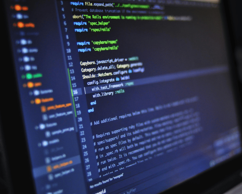 Close-up of a computer screen displaying programming code in a text editor, with syntax highlighting in multiple colours.