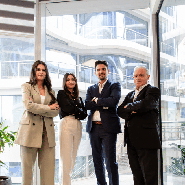 A2CO accounts team standing together in the office with a professional and confident look.