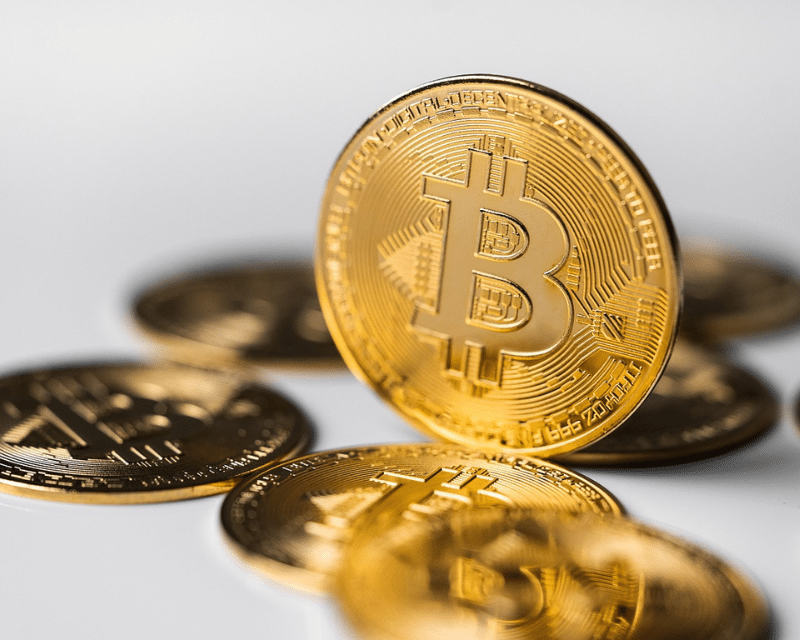 Stack of Bitcoin coins representing A2CO’s crypto and fintech advisory solutions.