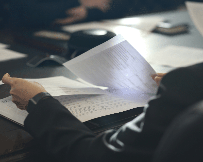 A2CO client signing corporate documents during a business meeting.