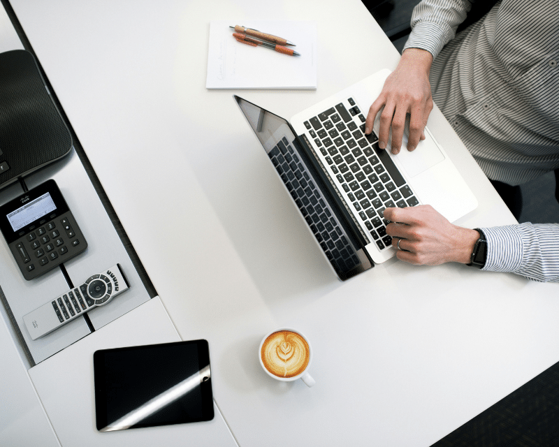 A2CO accountant using calculator to review financial statements.